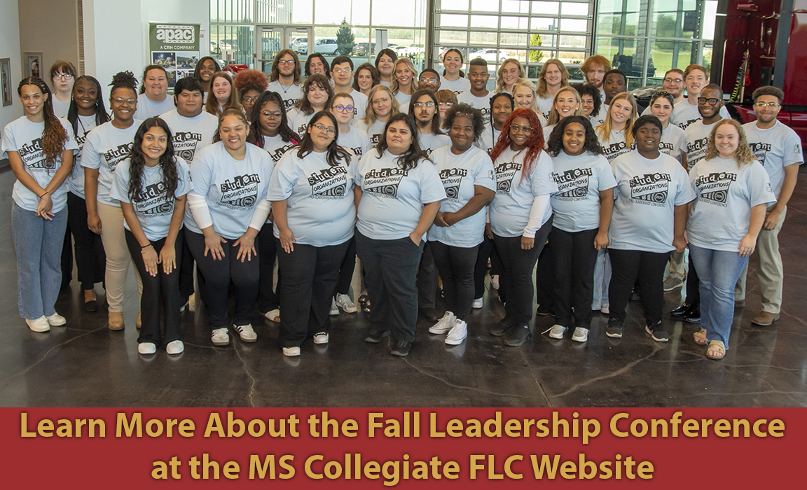 Attendees poise for group photo with their conference day tee-shirt